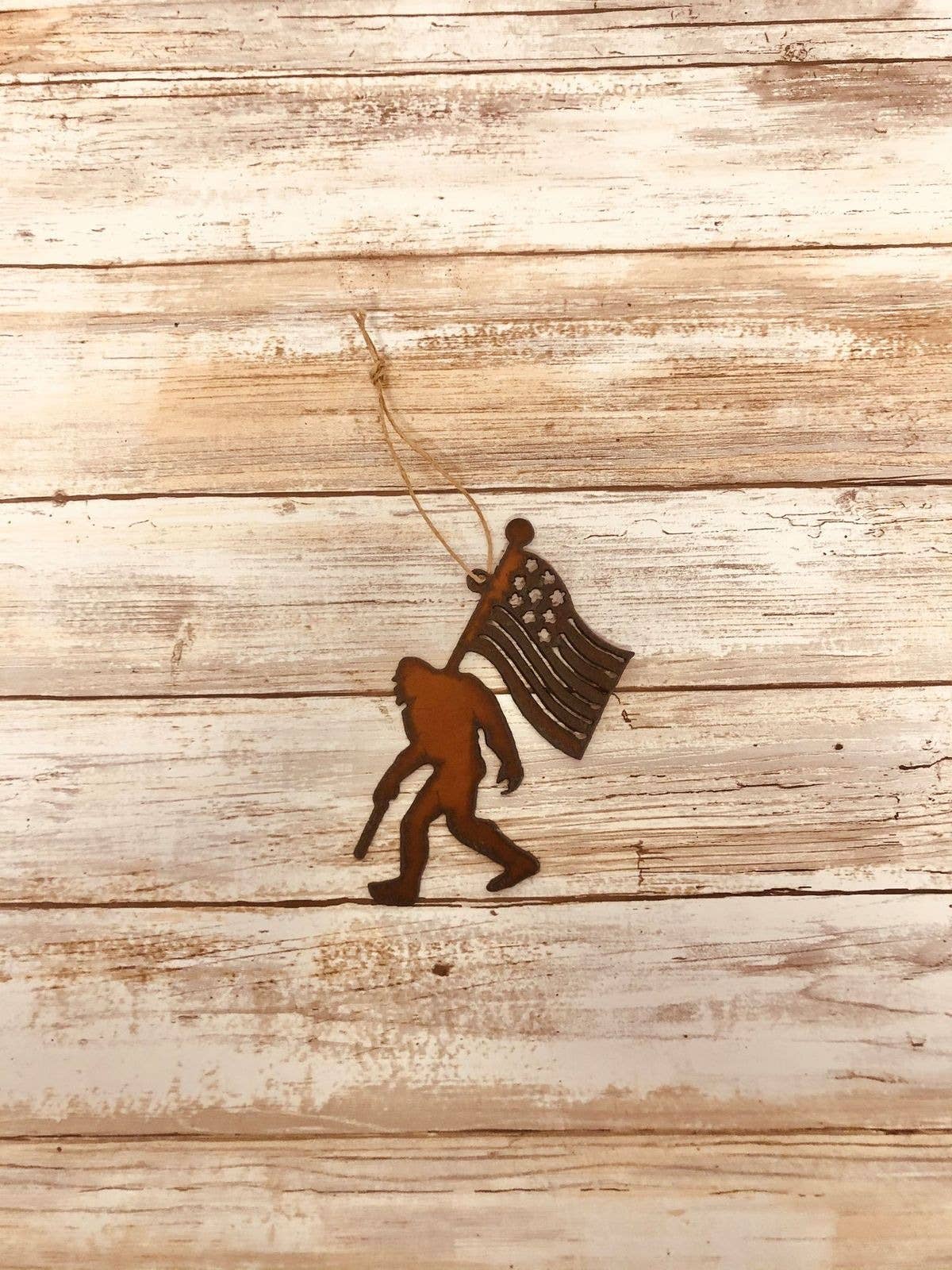 Universal Ironworks Inc - Bigfoot with Flag Rustic Ornament