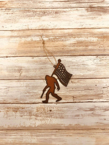Universal Ironworks Inc - Bigfoot with Flag Rustic Ornament